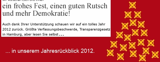 Auf dem Bild ist eine Grußkarte, mit den Worten "Wir wünschen Euch und Ihnen ein frohes Fest, einen guten Rutsch und mehr Demokratie!".