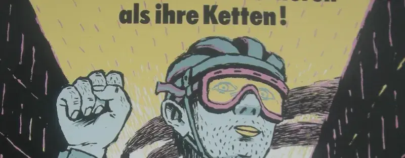 Ein gezeichneter Mensch mit der Überschrift "Radfahrer haben nicht zu verlieren als ihre Ketten!", ist auf dem Bild zu sehen.