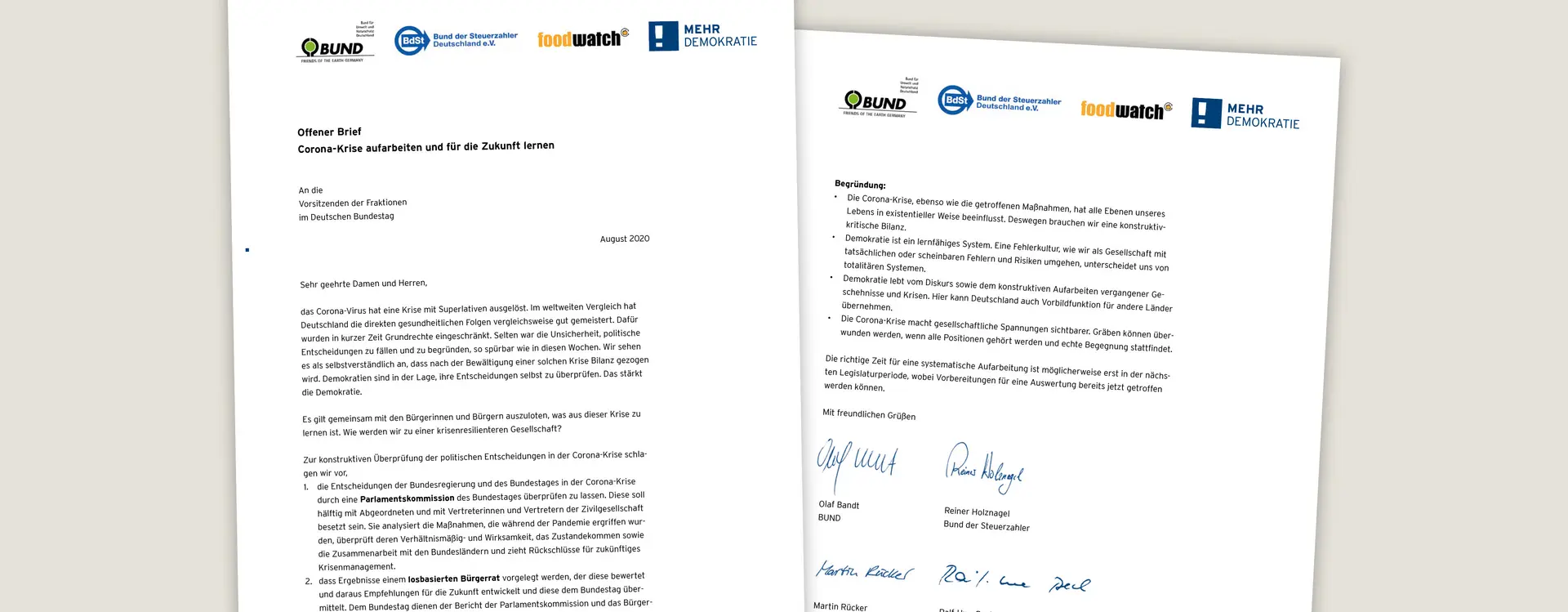 Ein Brief mit zwei Seiten ist zu sehen, der am Ende unterschrieben ist von mehreren Personen.